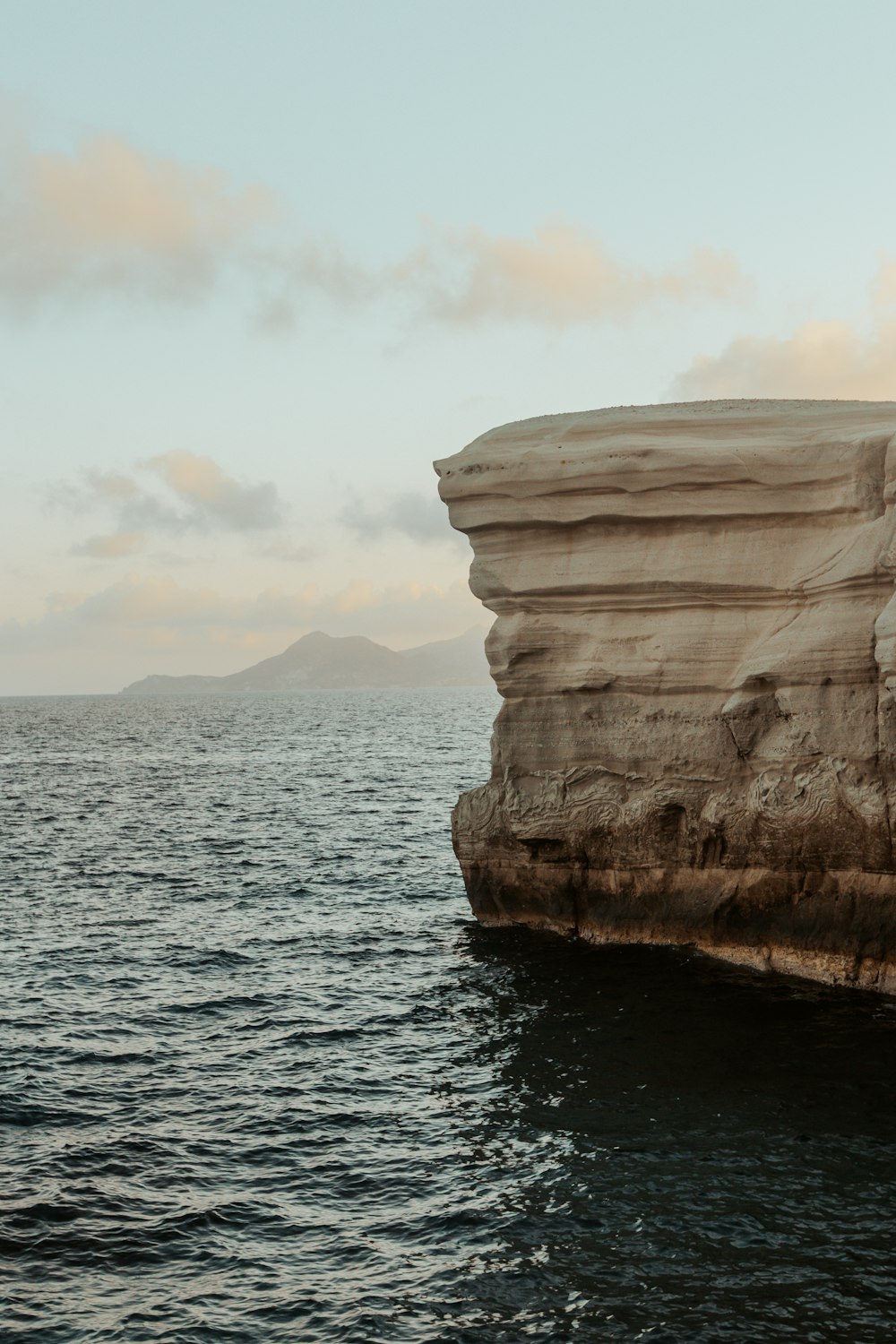 a large rock outcropping in the middle of a body of water