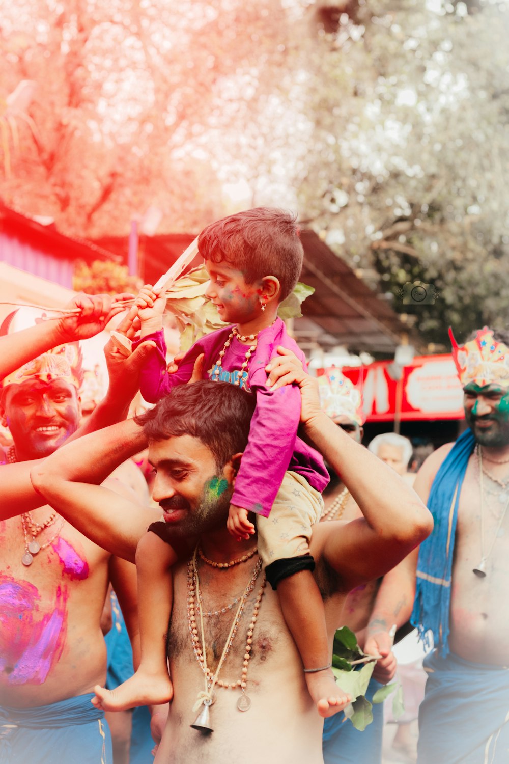 a man holding a child on his shoulders