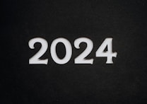 White numbers forming the year 2024 stand prominently against a dark, textured background.