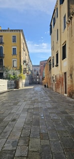 A serene cobblestone street bathed in soft morning light, with historic European buildings gently fading into the mist.