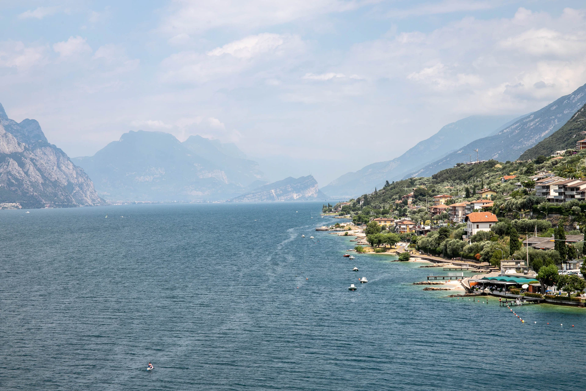 a body of water surrounded by mountains and houses