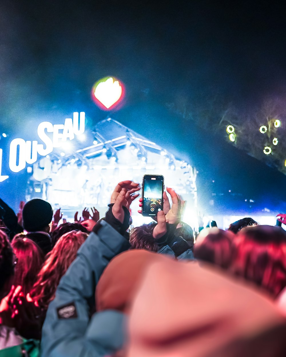 a crowd of people standing around a stage