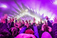 Dynamic photo of a corporate event with stage lights and engaged audience.