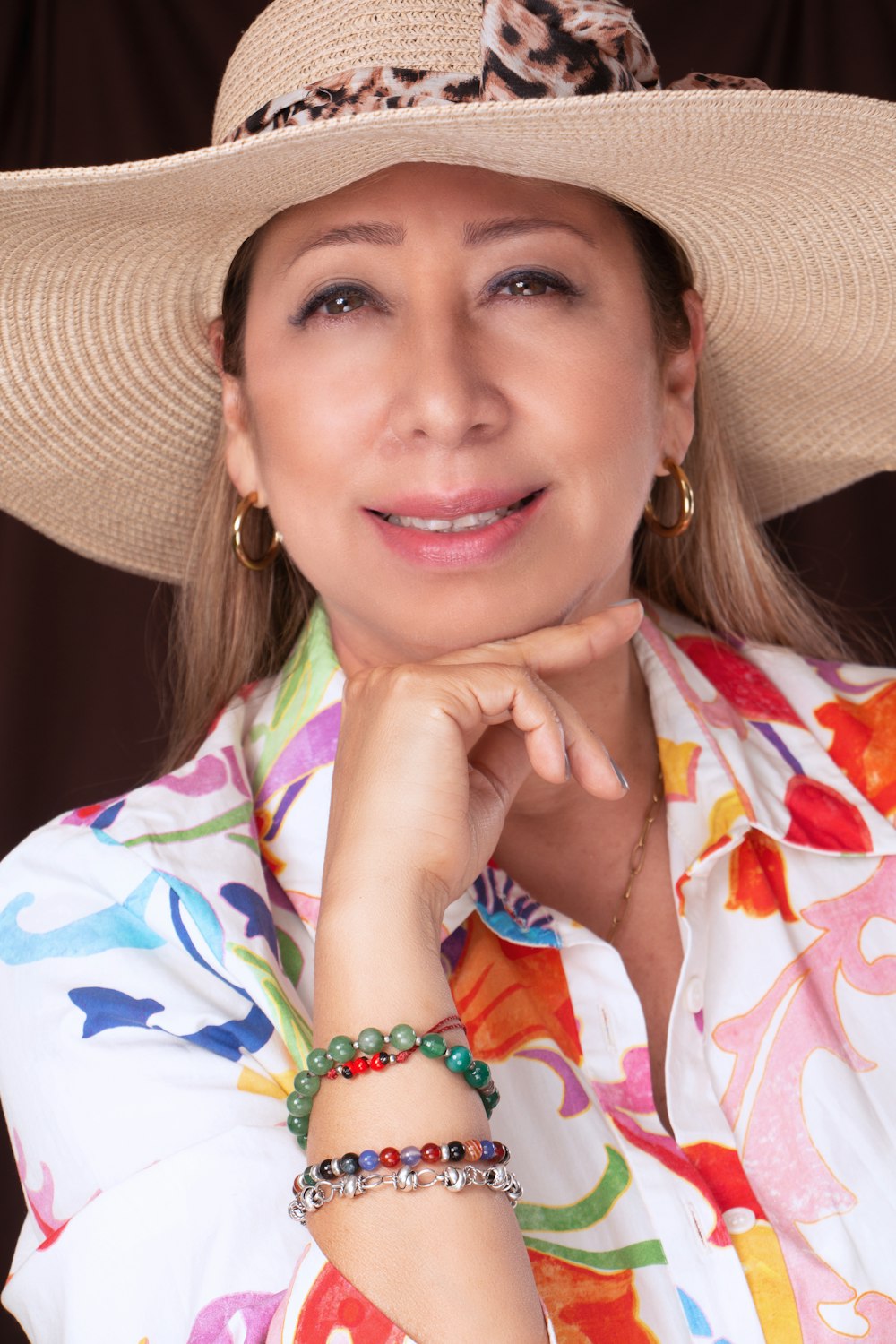 a woman wearing a hat and a colorful shirt