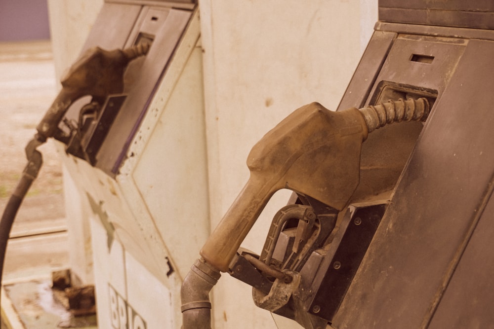 a close up of a gas pump with nozzles