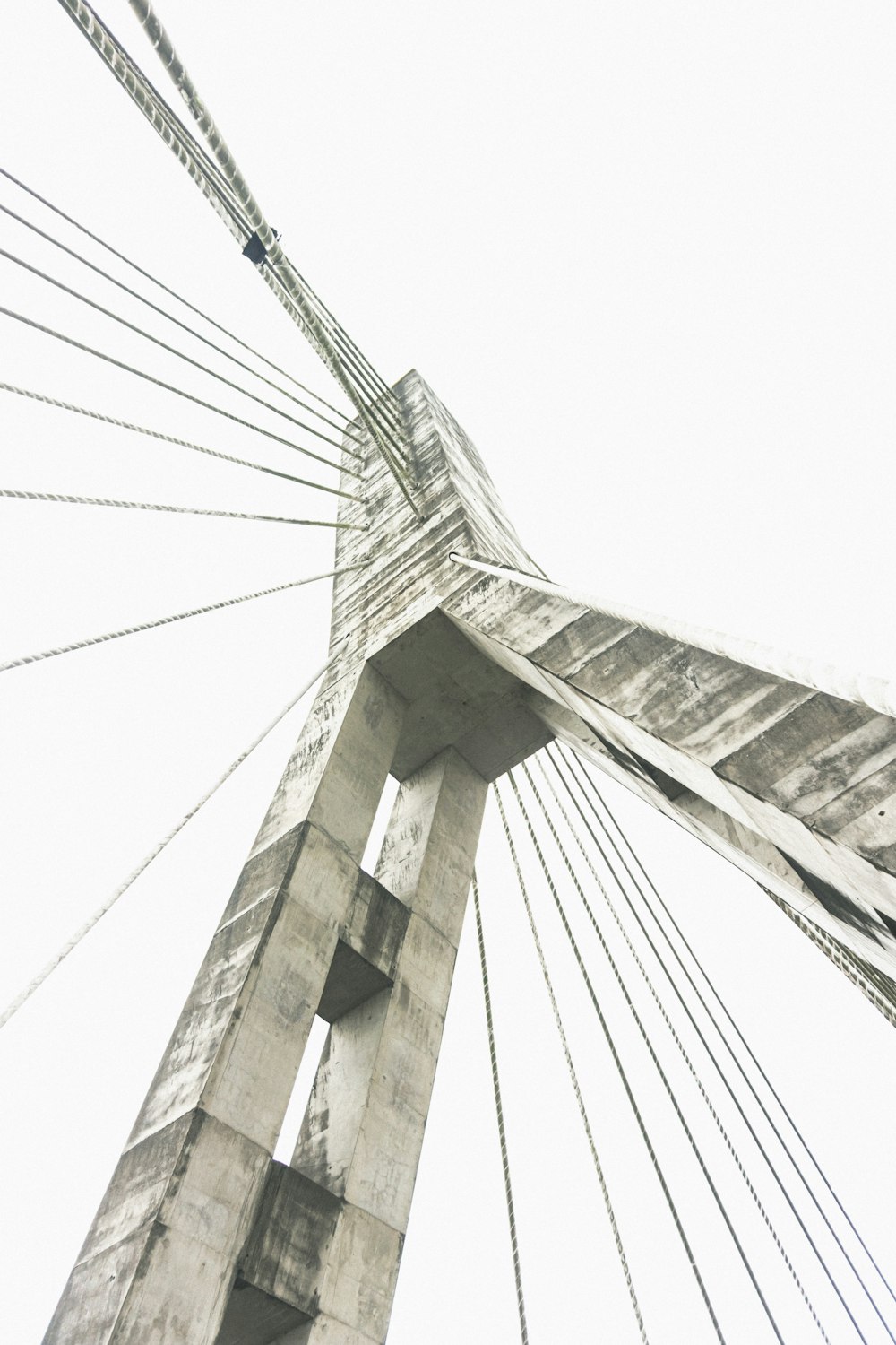 a black and white photo of a very tall bridge