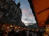 Crowd enjoying a lively outdoor food market at dusk.