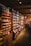 A nostalgic village grocery store filled with colorful produce and rustic wooden shelves.