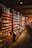 An interior of a vintage-style store is filled with shelves stocked with an assortment of goods, including packaged foods and glass jars. The room features warm wooden shelving and flooring, creating a cozy and nostalgic atmosphere. Soft lighting enhances the rustic charm of the setup.