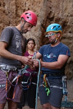 a man holding a rope while standing next to a woman