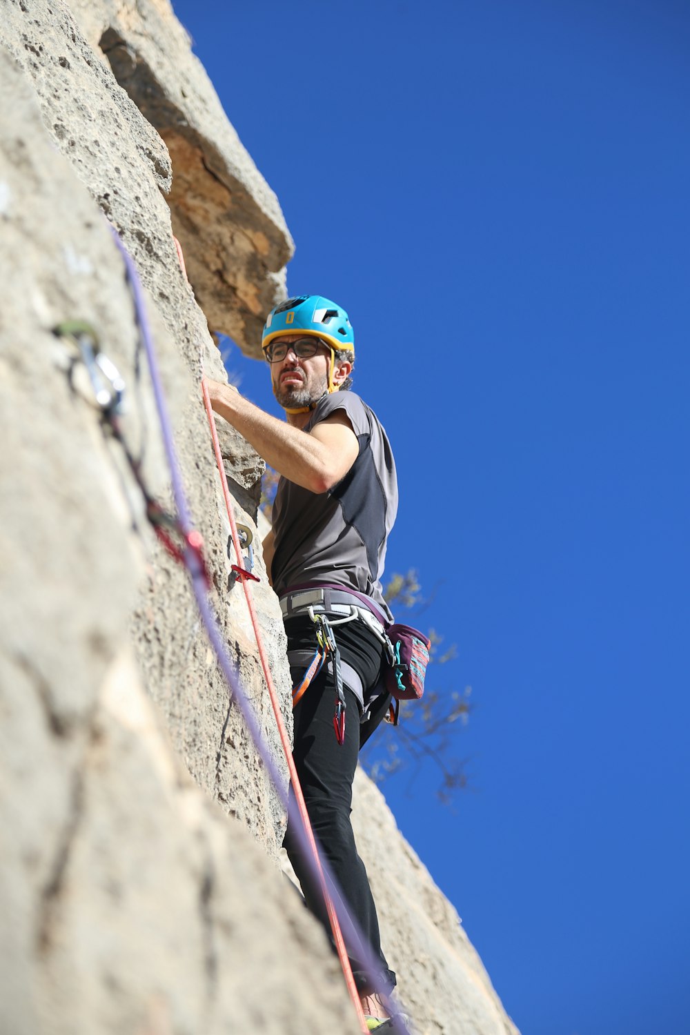 a man climbing up the side of a mountain