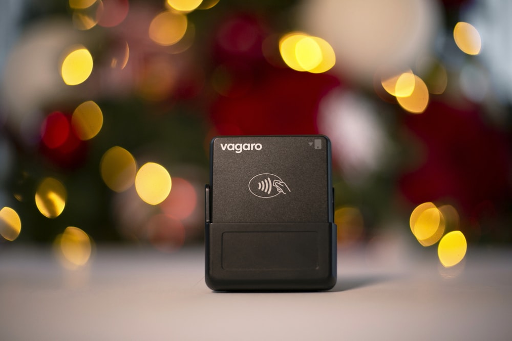 a compact device sitting on a table in front of a christmas tree