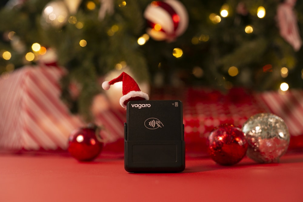 a cell phone sitting in front of a christmas tree