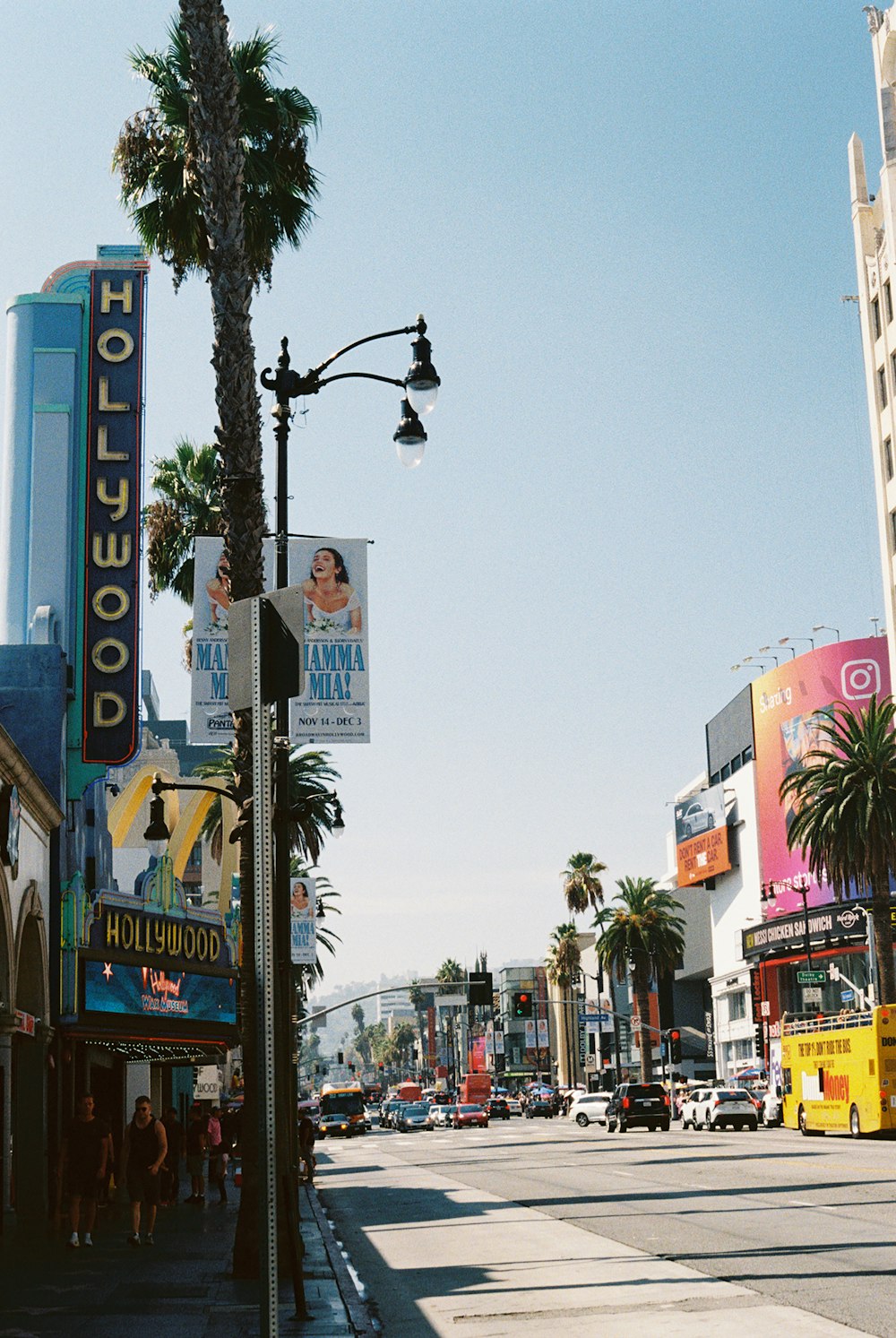 a city street with palm trees and buildings