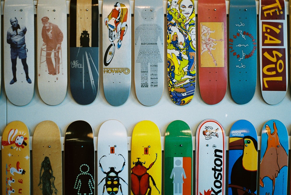 a bunch of skateboards are lined up on a wall