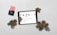 A tablet displaying a Christmas-themed promotion is placed on a light surface alongside pine cones and evergreen branches. A black payment card reader with a pink card inserted is positioned to the left.