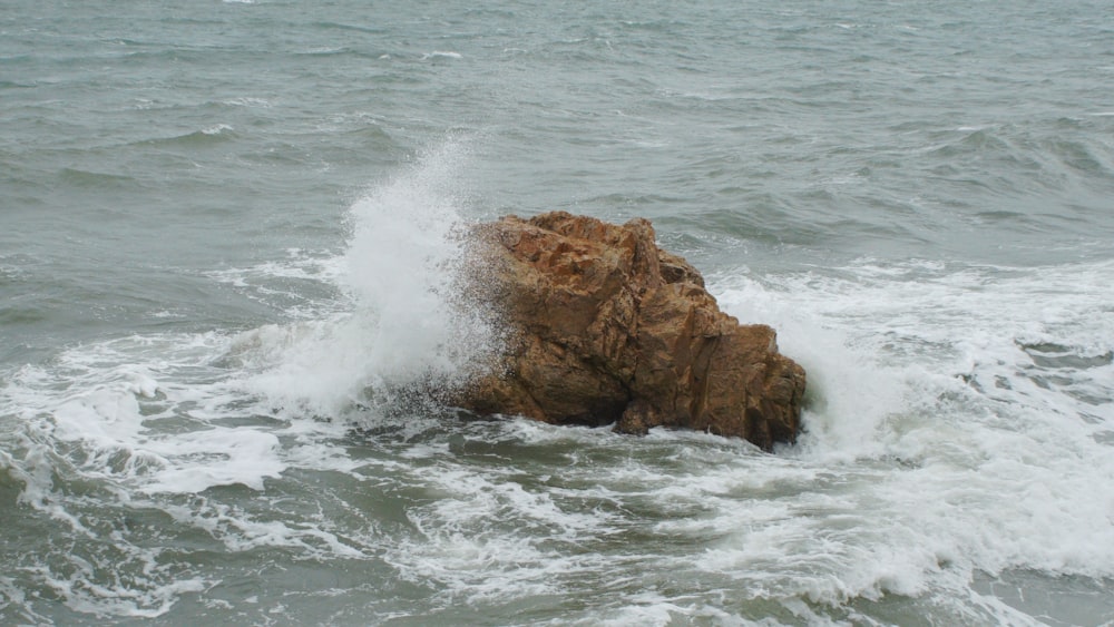 a large rock sticking out of the ocean