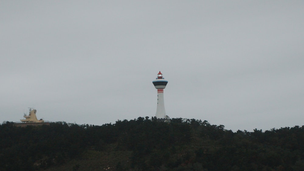 a tower on top of a hill with a sky background
