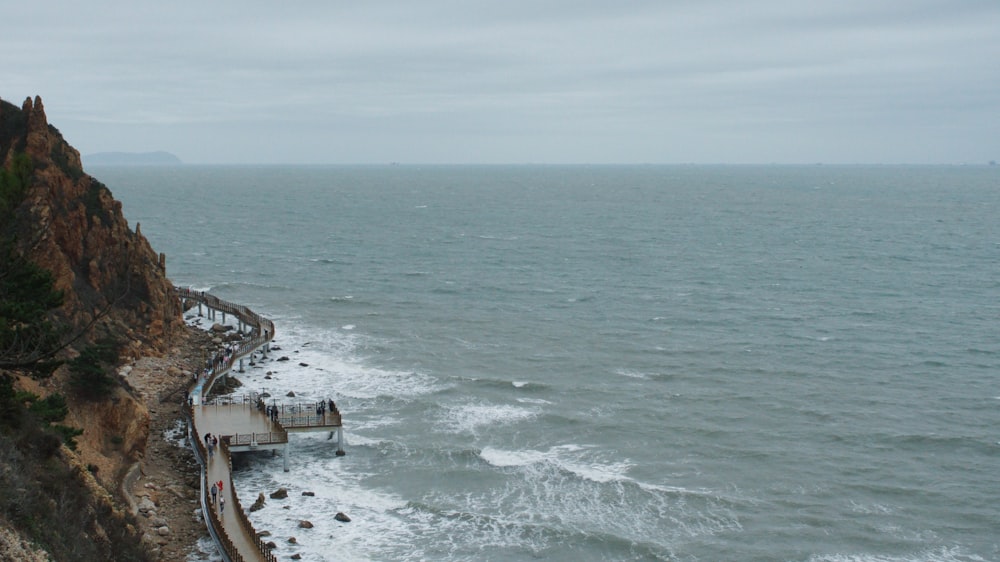 a pier on the edge of a cliff overlooking the ocean