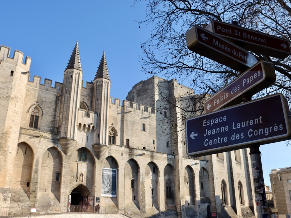 a street sign in front of a castle