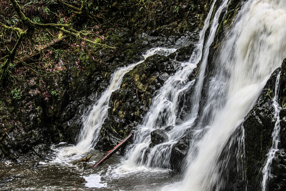 a waterfall with water cascading down it's sides