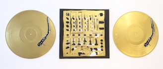 Golden vinyl records and stereo equipment styled on a black surface, reflecting DJ Claude’s premium aesthetic