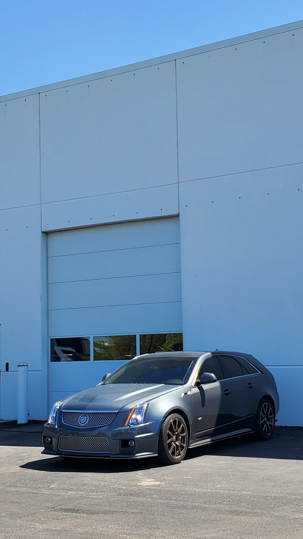 a silver car parked in front of a building