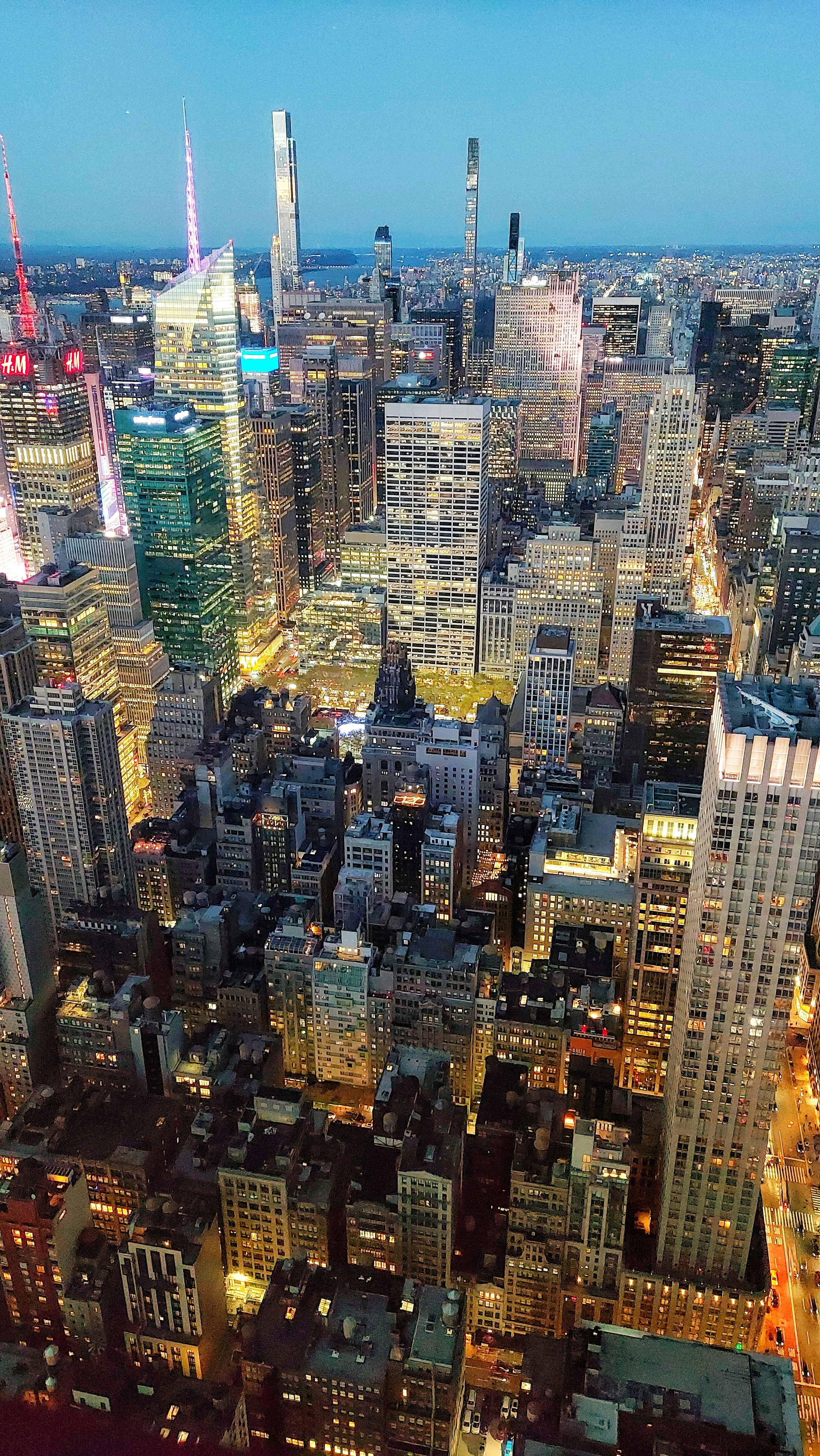 Aerial view of global city skyline at dusk — dense urban infrastructure, international commerce hub