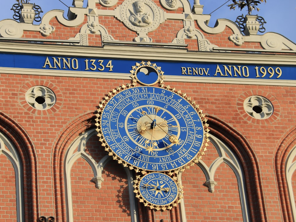 a large blue and gold clock on the side of a building