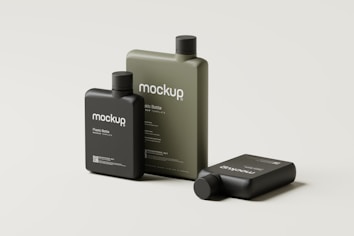 Three plastic bottles are arranged against a light gray background. The bottles vary in size and are labeled with the word 'mockup' in a minimalist style. Two of the bottles are standing upright, while one is lying down.