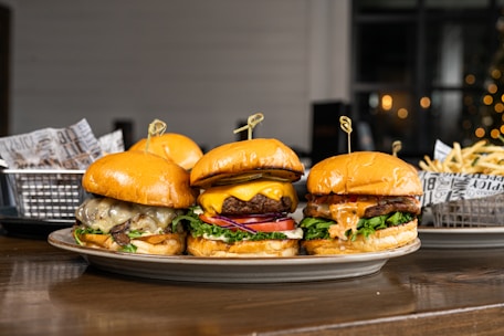 A vibrant platter showing a variety of gourmet burgers with colorful toppings and crispy fries.