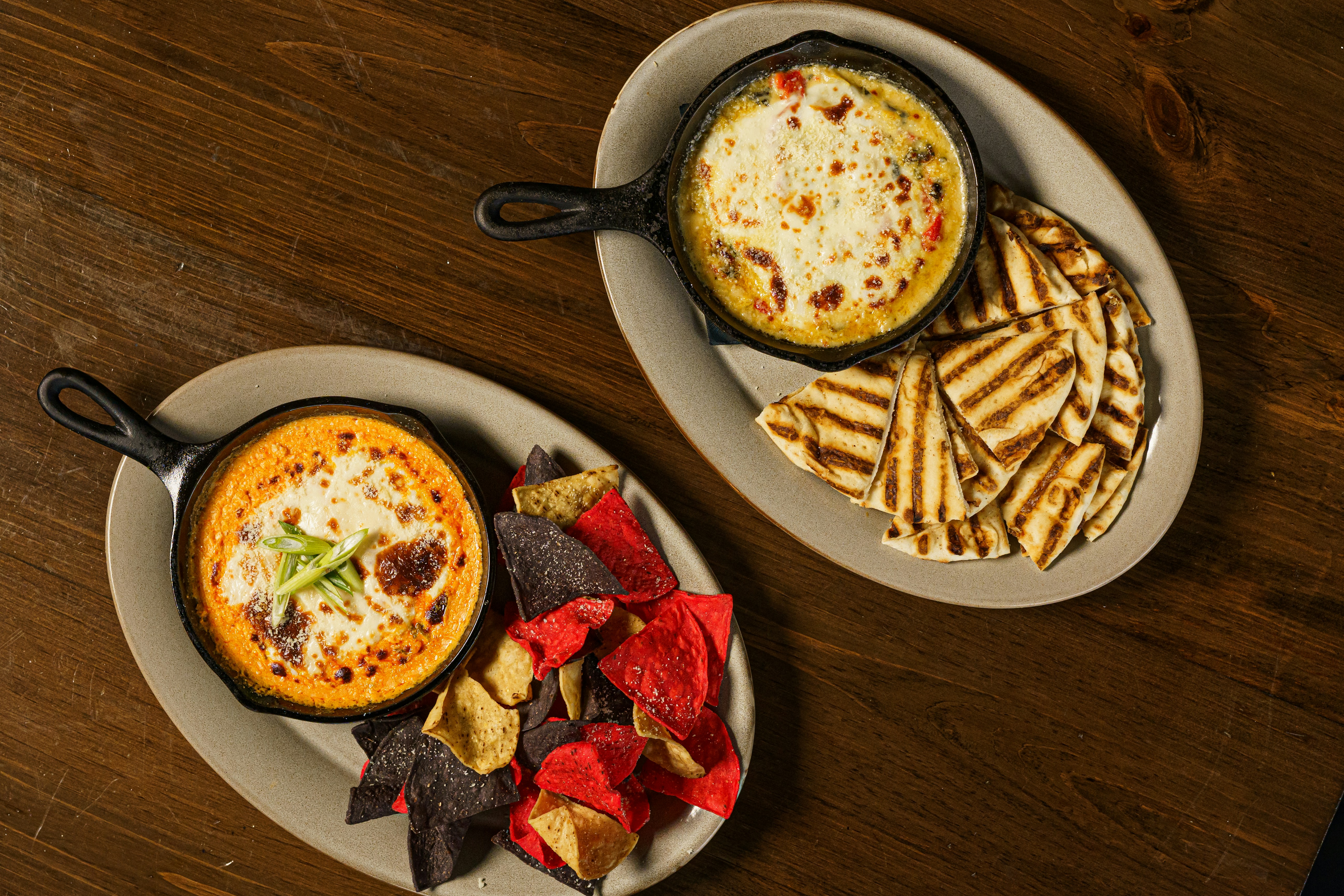 two plates of food on a wooden table