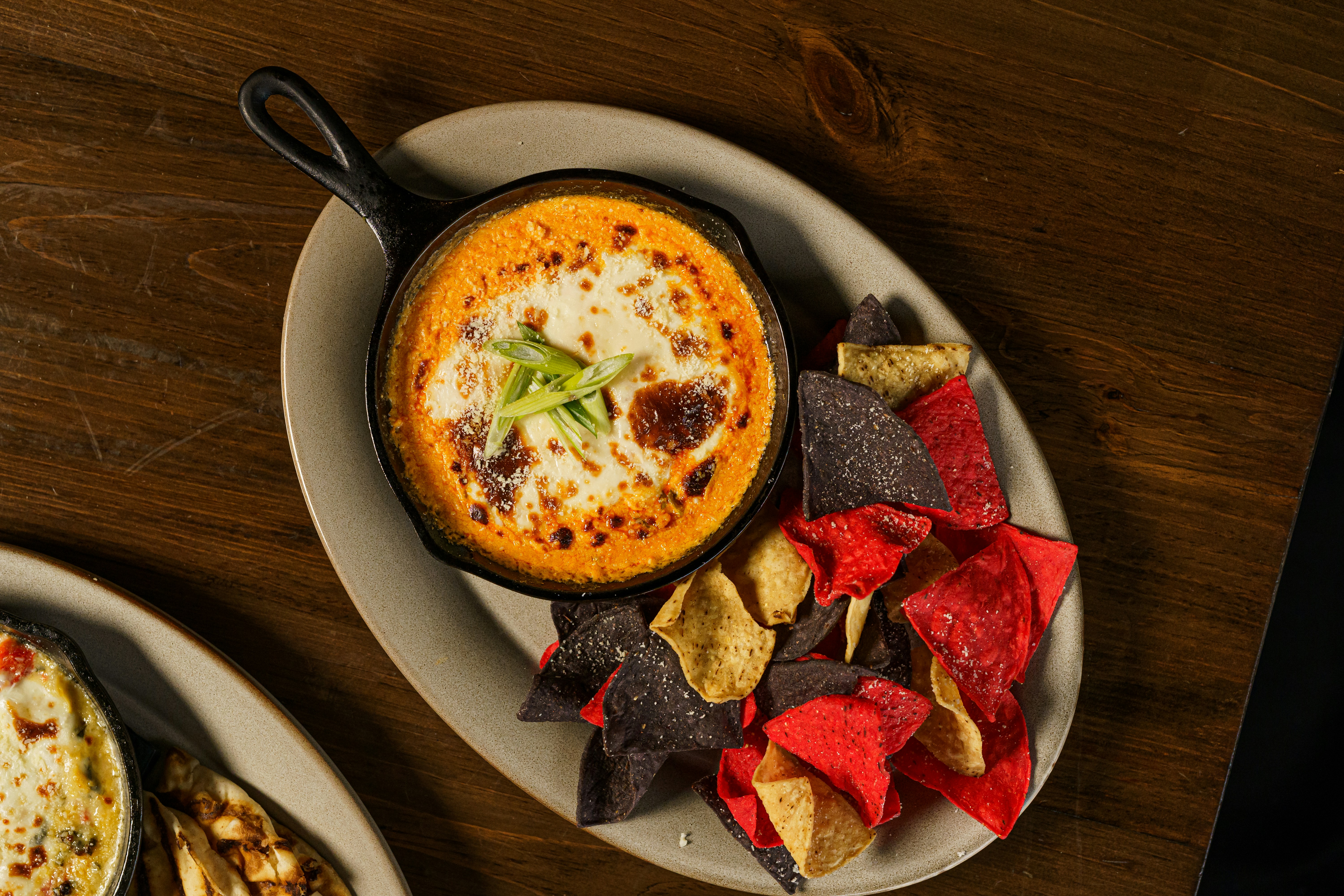 two plates of food on a wooden table