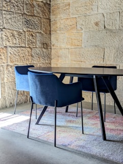 Contemporary dining area highlighted by a vibrant carpet under the table.