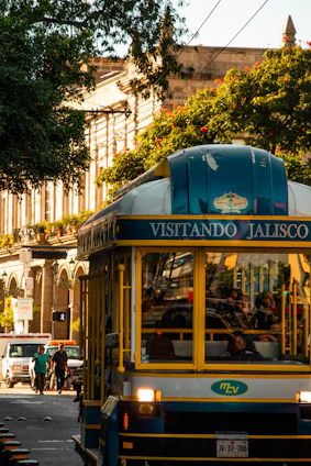 a blue and yellow trolley car traveling down a street
