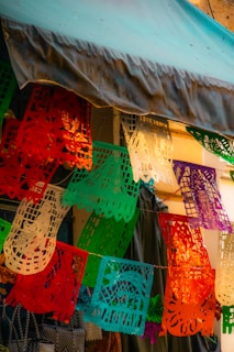 Colorful printed banderines hanging in a festive outdoor setting.