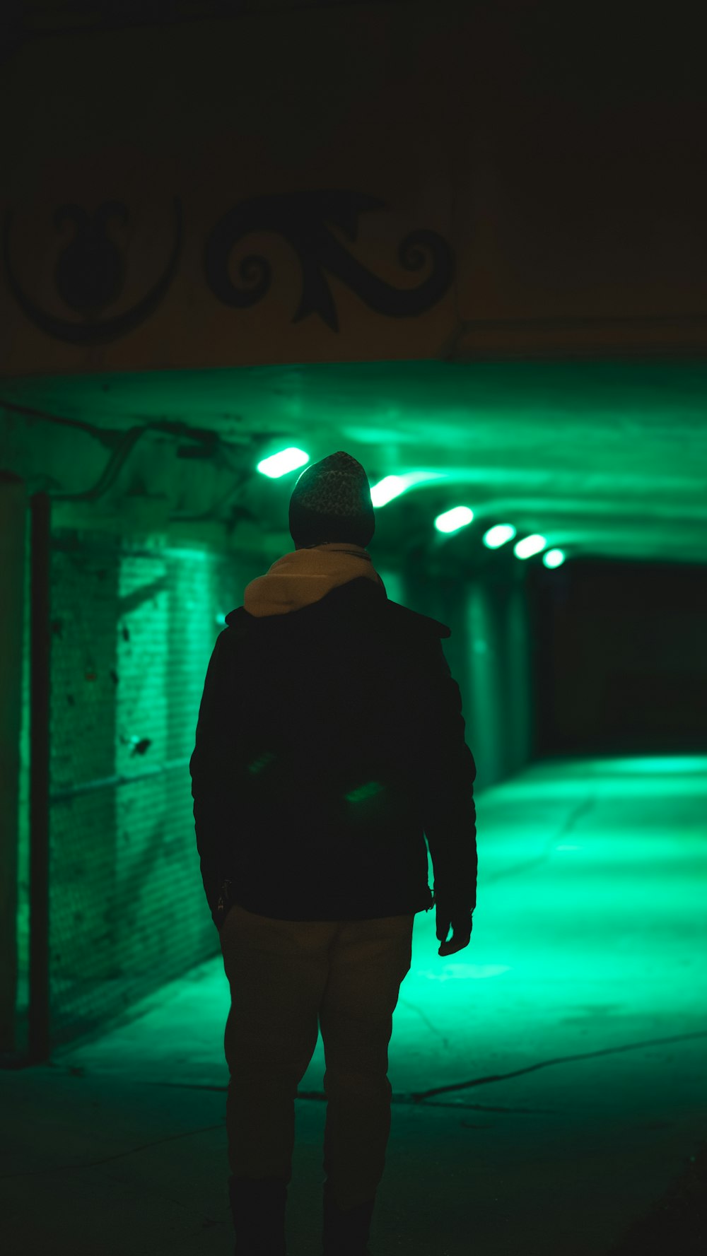 a man walking down a dark street at night