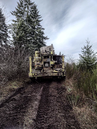 Heavy machinery parked near a wetland area, threatening local wildlife habitat.