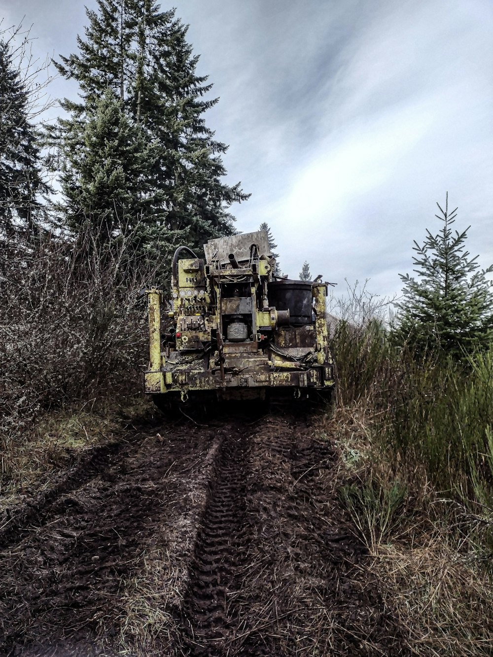 a large truck driving down a muddy road