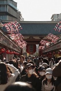 A bustling street market in Tokyo filled with colorful lanterns and lively crowds.