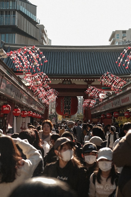 A bustling street market in Tokyo filled with colorful lanterns and lively crowds.