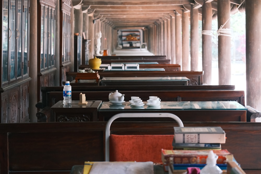 a row of tables with tea cups on top of them