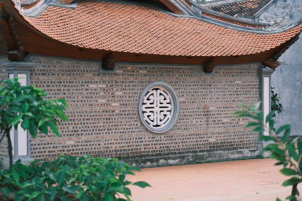 a building with a decorative roof and a circular window