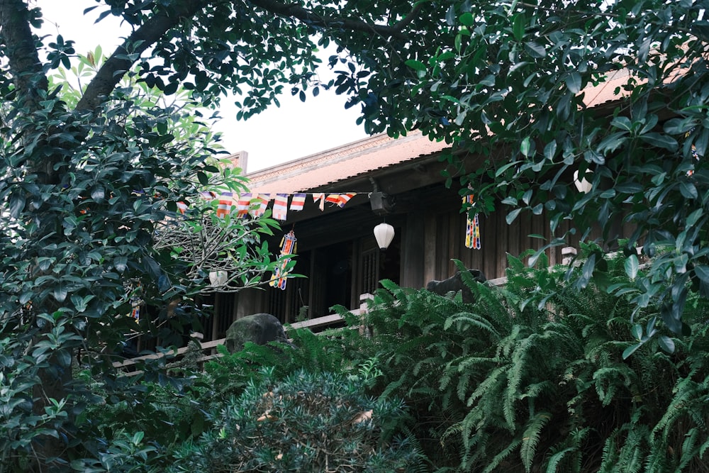 a house is surrounded by greenery and trees