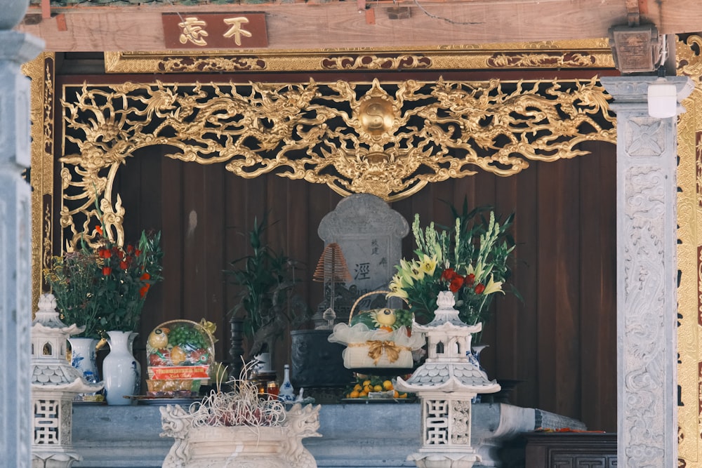 a shrine with flowers and statues in it