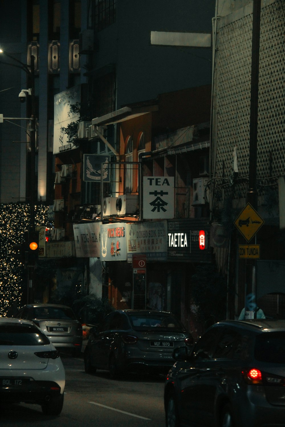 a city street filled with lots of traffic at night