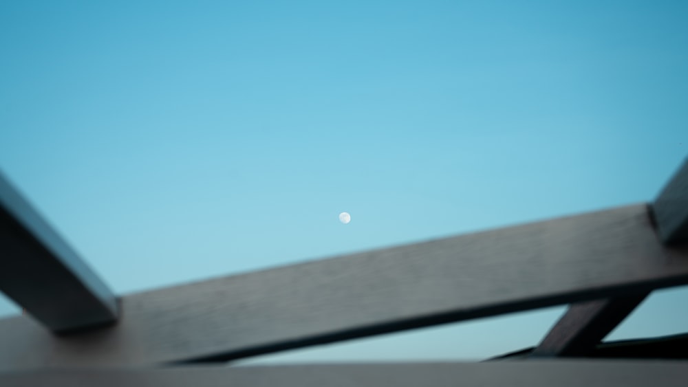 a view of the moon from a bridge