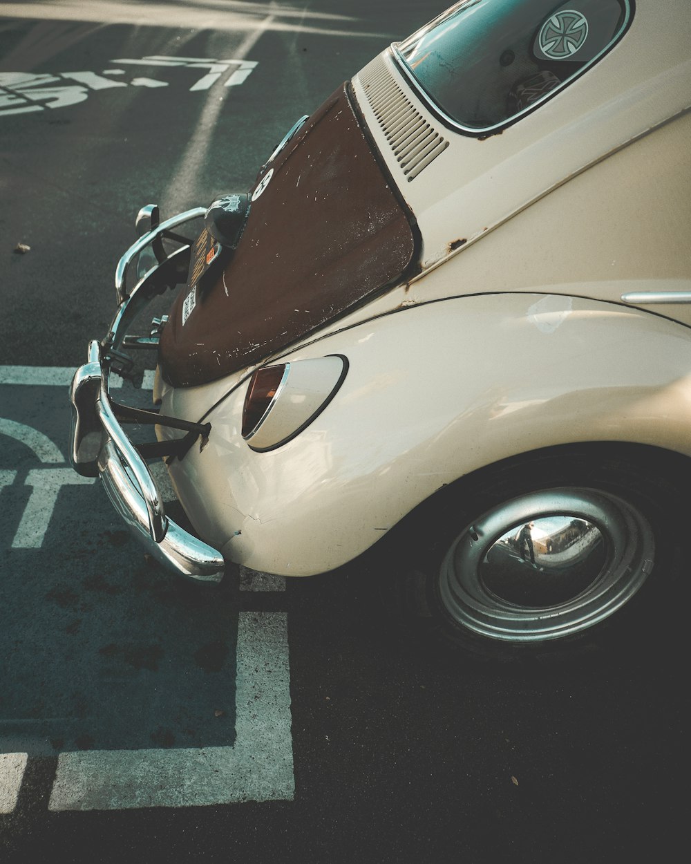 an old car parked in a parking lot