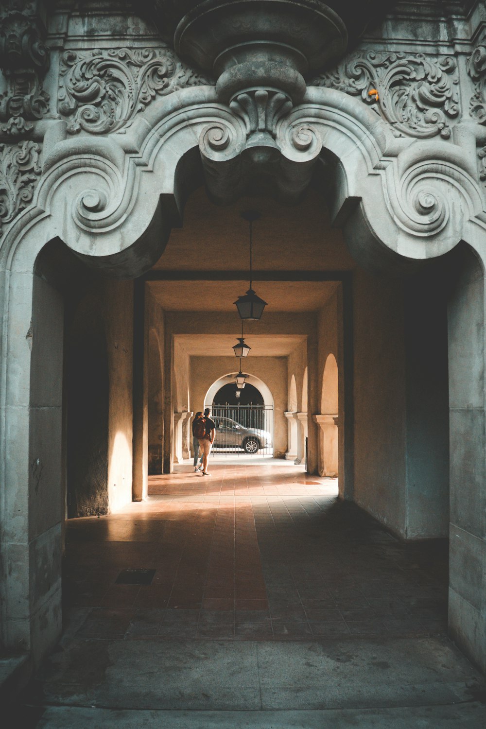 a man is walking through a tunnel in a building