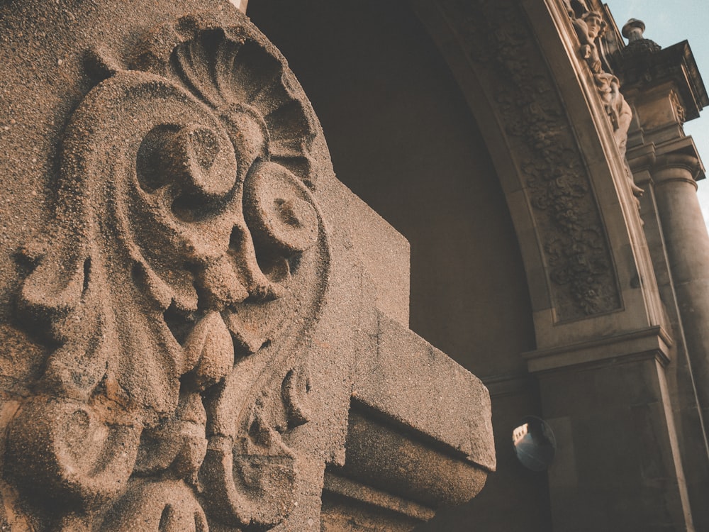 a close up of a stone carving on the side of a building